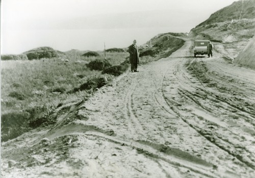 Photograph showing car and pedestrians on Sandy Road at Fairhaven G.O.R. 1920's