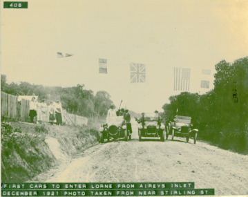 First cars to enter Lorne,  Dec1921, from Aireys Inlet. Photo taken from near Stirling St, three cars with passengers and spectators