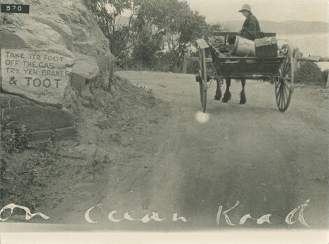 Horse and dray on GOR with sign written on rock 
