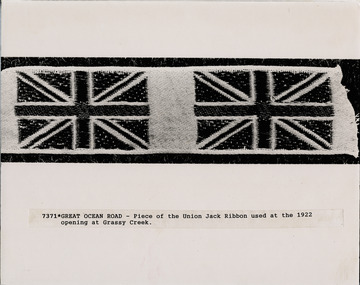 Piece of ribbon showing two union jacks used at opening of Great ocean Road at Grassy Creek in 1922