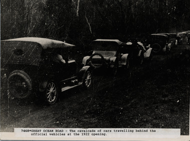 Series of cars on the road following official vehicle at opening of G.O. R. 1922 (official vehicle not visible)