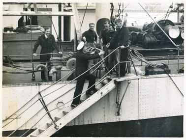 Reverend Frank Oliver on the gangway for a ship visit is welcomed by the crew.