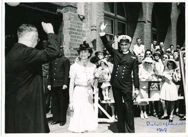 H.R.H. Duchess Alice of Gloucester standing next to Padre Frank Oliver saluting the crowd during a Royal visit to Mission to Seamen