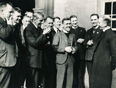 Group of chaplains standing and shilling while they are talking.