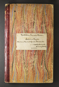 Large book with coloured cover and red binding along spine.