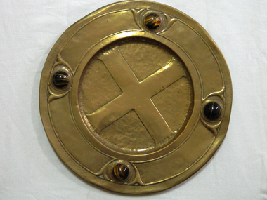 Large brass circular plate with the symbol of the cross engraved  in the centre