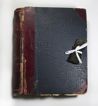 Thick scrapbook collecting newspaper clippings and images
