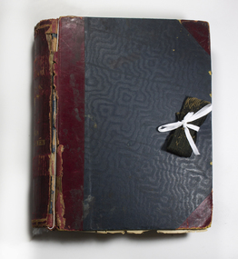 Thick scrapbook collecting newspaper clippings and images