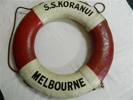 White and red life buoy with S.S. Koranui written in black capital letters