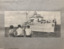 Photograph depicitng three children watching of a ship at sea