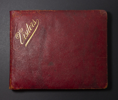 Rectangular shaped book covered in burgundy leather with golden letters on the left top corner: Visitors