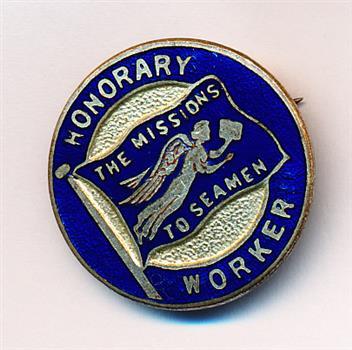 Small round blue entame badge depicting the flying angel flag of the Missions to Seamen