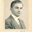 A black and white portrait photograph, mounted on a cream cardboard frame, of Allan Quinn as a young man. At the bottom written in ink: New York, September 1948.