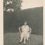  Lillie Duncan  sitting on a cane chair in a garden