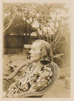 Olive Duncan seated on a rattan in a garden
