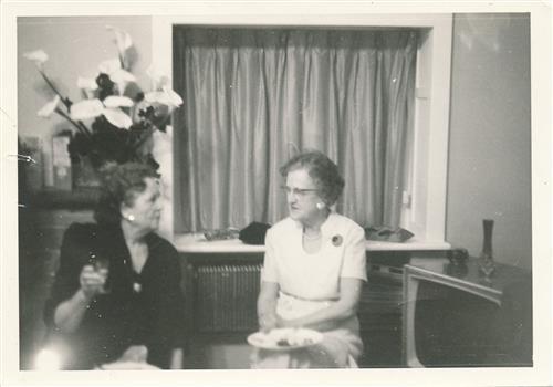 Two senior women pitted in a lounge and talking to each other