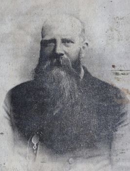 Black and white photograph of man with long beard
