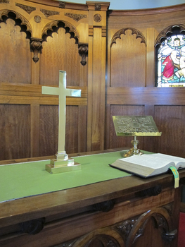 Cross in situ with altar lectern in the sanctuary of the St Peter Chapel.