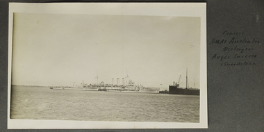 Military ships berthed in port.