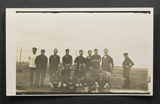 Football team with 3 rows of standing, kneeling and sitting men