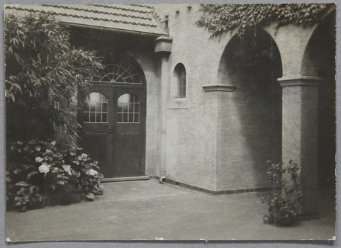 Black and white photograph depicting the courtyard showing side entrance to the chapel