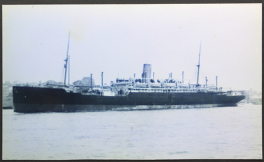 Black and white photograph of a passenger liner in port
