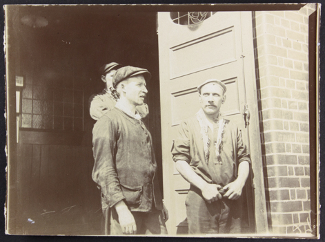 Three seamen standing in front of the Siddeley Street Mission 