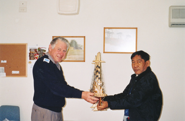 Photograph, Keith Dann with model ship and volunteer or seafarer