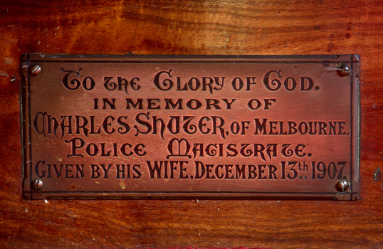 Small rectangular plaque in memory of Charles Shuter fixed to the St Peter chapel altar.
