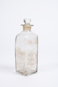 Clear glass  squared-base medicine container  with glass lid.