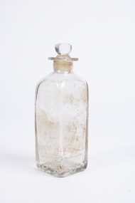 Clear glass  squared-base medicine container  with glass lid.
