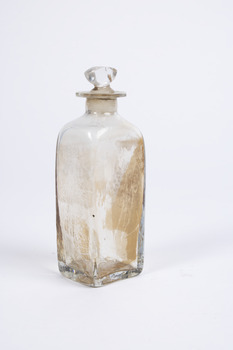 Clear glass  squared-base medicine container  with glass lid.