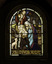 Arch stained glass window depicting the birth of Jesus with a text in memory of Linda Kerferd