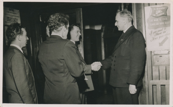 Black and white photograph of Pader Oliver sharing hands with seamenre
