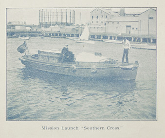 Wooden boat with two men on board on the Yarra River