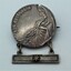 Mothers and Widows Badge 1939-1945 issued to Mrs. M Deacon to commemorate her son Flying Officer Stanley Alfred Deacon. The star on the panel of the Mothers and Widows Badge designated the number of sons that had died in the war. The name of the recipient is etched on the back of the medal.