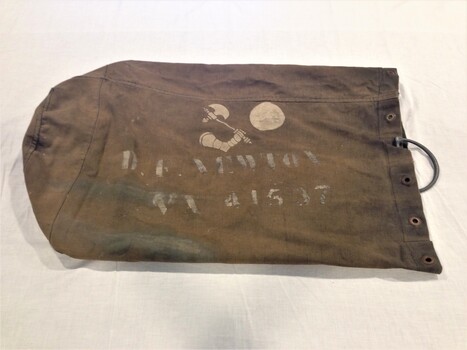Side view of bag showing stencil inscription
