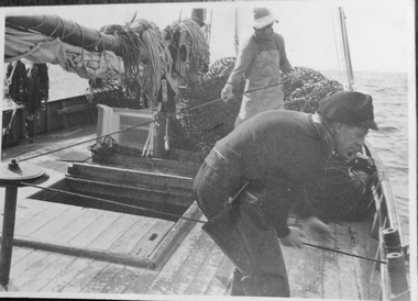 Photograph, Fishermen working on boat, Possibly 1950s