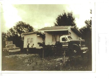 Photograph, House moved by truck, Mid 20th century