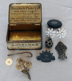 tobacco tin of assorted items, 1920-1950