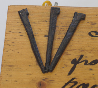 nails on board, 1885