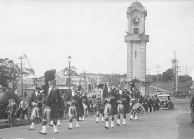 Photograph, Anzac Day. Caledonian pipe band in march through Ringwood. c1940's