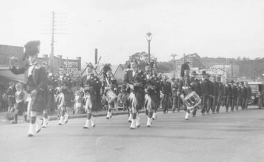 Photograph, Anzac Day, Caledonian pipe band marching through Ringwood. c1940's