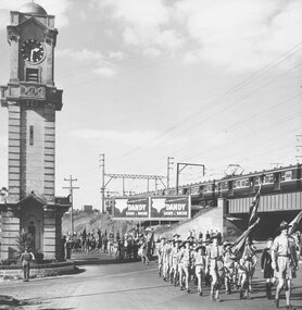 Photograph, Anzac Day, scouts marching past Ringwood clock tower 1958