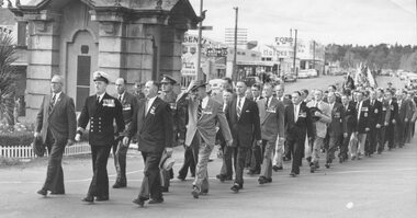 Photograph, Anzac Day, marching past Ringwood clock tower. c1950's