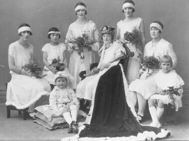 Photograph, Ringwood (Victoria) Queen Carnival c.1923. Standing L-R: Maxie Benson, Vera Simpson. Seated: Nell Lawlor, Dorothy Matlock, Mary O'Regan (Queen), Amy Connell, Kathleen Sherlock.  Page boy on cushions is Ted Matlock