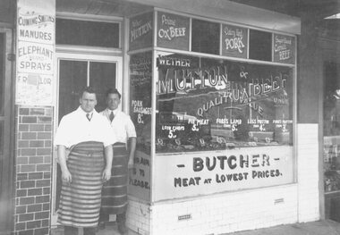 Photograph, Mr M.B. Smith, butcher, standing behind Mr. Geo Pratt, assistant, at their shop east of Adelaide Street in Whitehorse Road, Ringwood - c.1924
