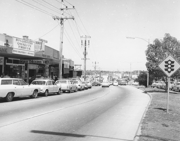 Photograph, Westerly view of approach to Wantirna Road showing shops on southern side of Maroondah Highway, Ringwood - 1972