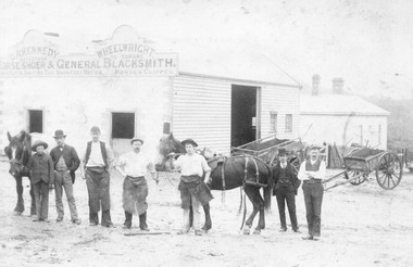 Photograph, Workers outside D.R. Kennedy's blacksmith shop, corner of Adelaide Street and Maroondah Highway, Ringwood.  David Robert Kennedy took over the business from Ringwood's original blacksmith - Tommy Grant, in 1894