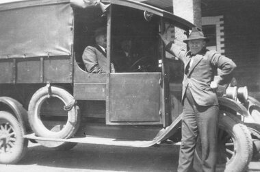 Photograph, Herman Pump in his truck.  A.J. Sugden, passenger.  Bert Richards standing outside Club Hotel, Ringwood. c1940's